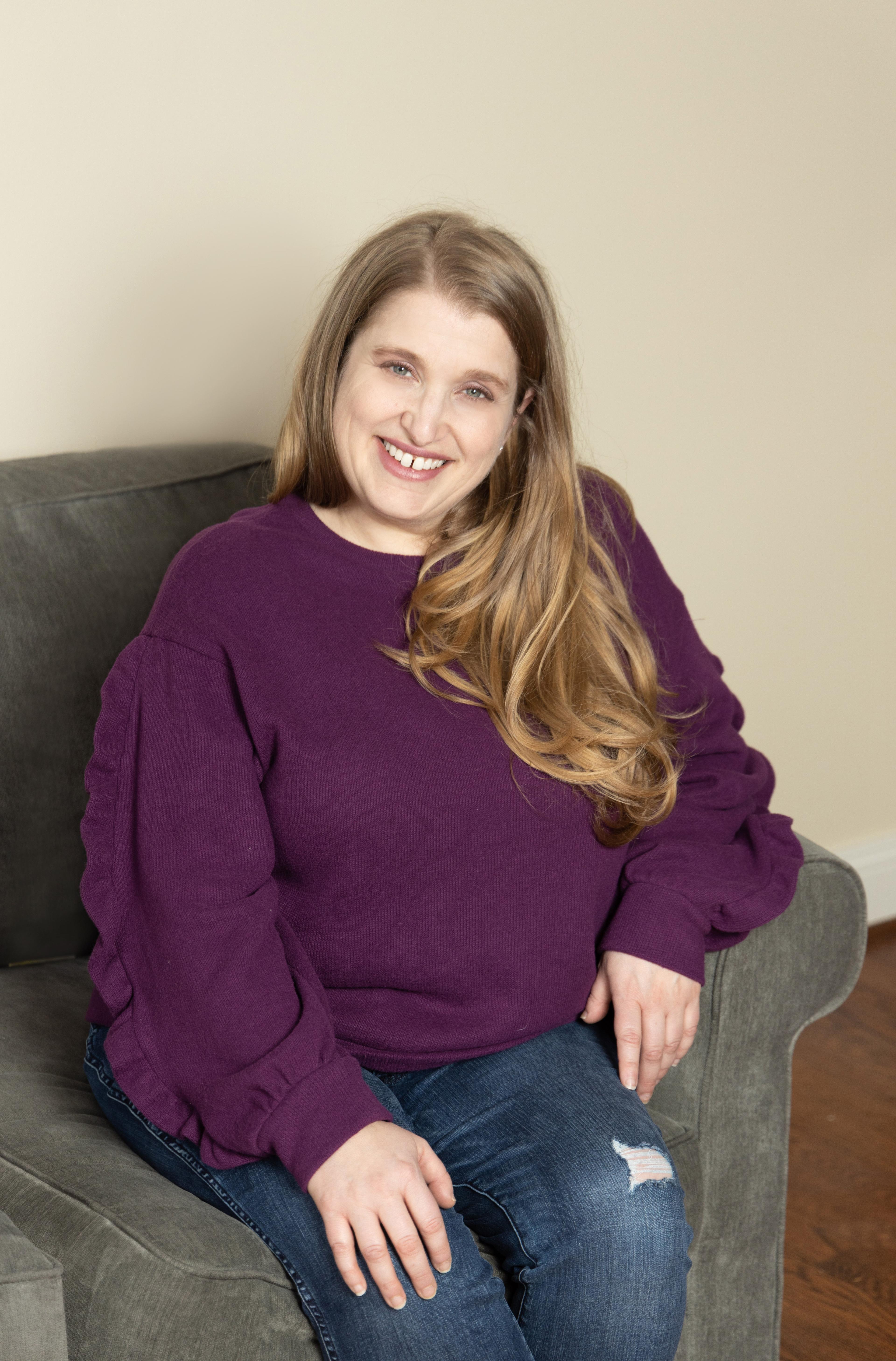 Franki in purple seated on couch branding pic.jpg